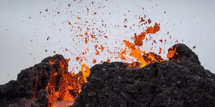 Lava flows from an eruption of a volcano on the Reykjanes Peninsula in southwestern Iceland on Saturday, March 20, 2021. The eruption of the long-dormant volcano that sent streams of lava flowing across a small valley in Iceland is easing and shouldn’t interfere with air travel, the Icelandic Meteorological Office said Saturday. (AP Photo/Marco Di Marco)