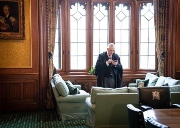 Speaker of the House of Commons Sir Lindsay Hoyle uses a mobile phone in his office in the Palace of Westminster, London. Picture date: Monday February 21, 2022. (Photo by Stefan Rousseau/PA Images via Getty Images)