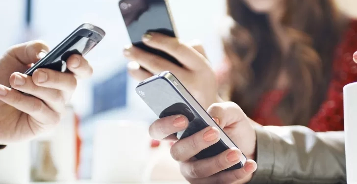 hands texting with mobile phones in cafe